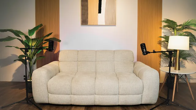 Cream sofa with two microphones and a floor lamp